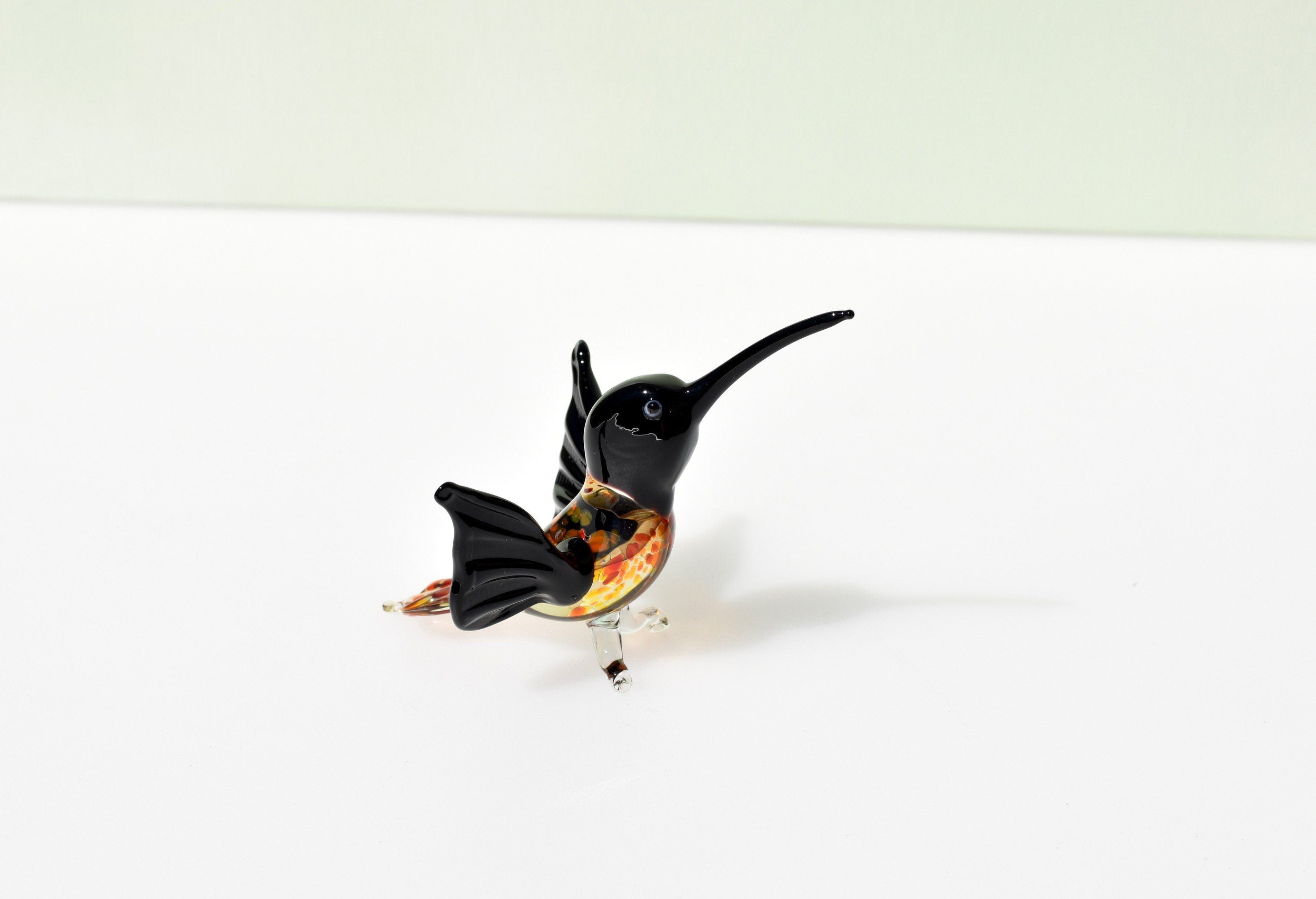Beautiful colored Glass clear black hummingbird. Detailed figurine with character and personality. Excellent addition to your collection.
