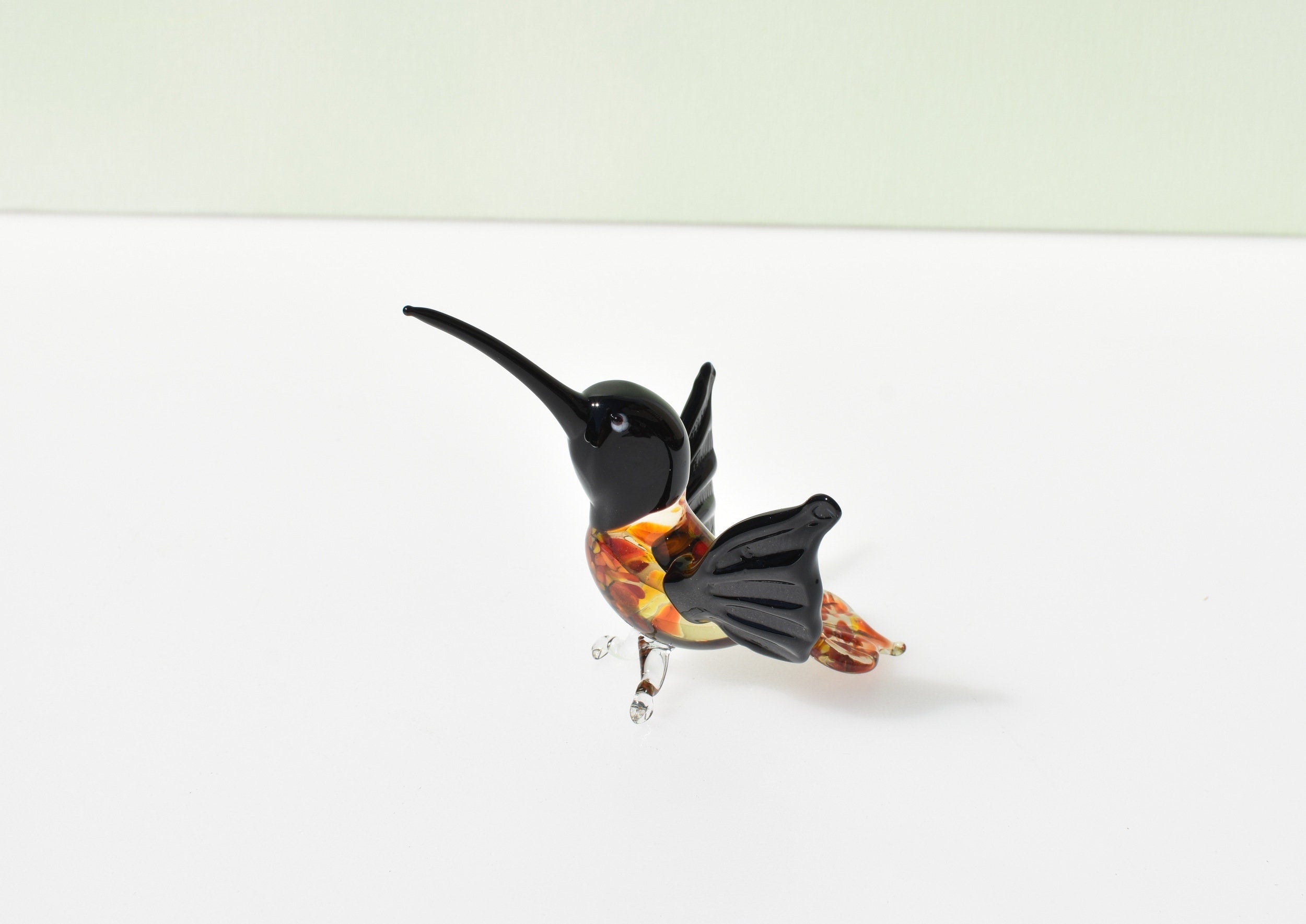 Beautiful colored Glass clear black hummingbird. Detailed figurine with character and personality. Excellent addition to your collection.