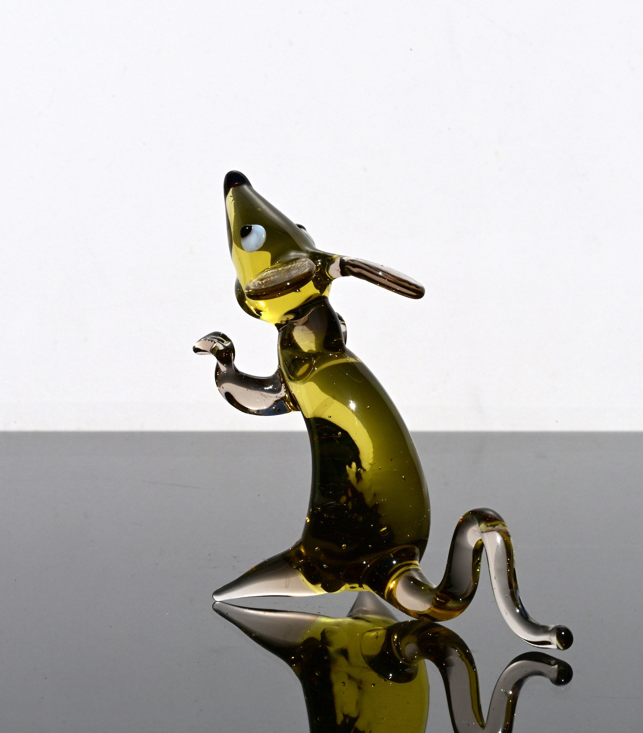 Cute amber- clear glass rat. Detailed figurine with a lot of personality. It's an excellent addition to your glass animals collection.