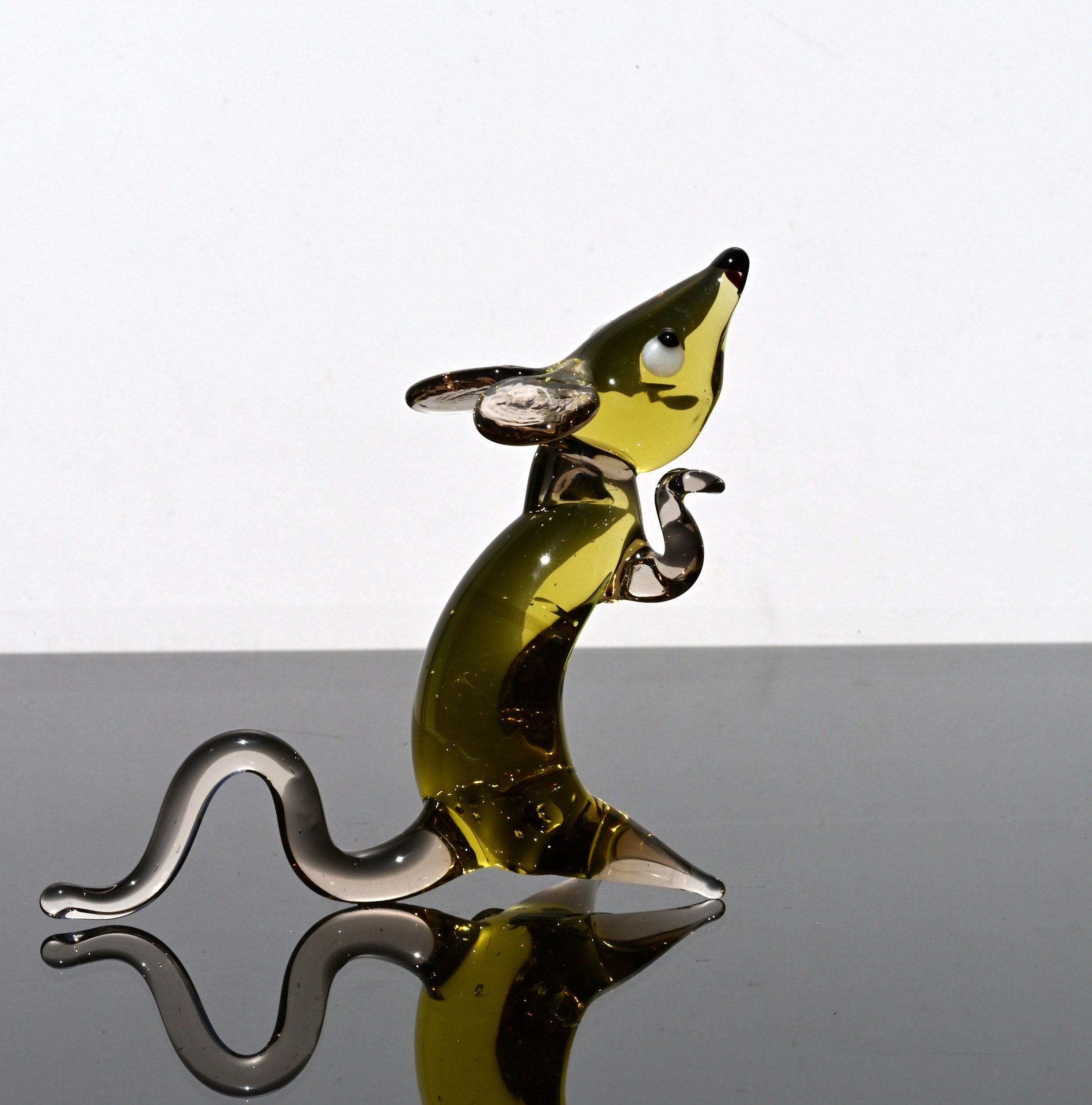 Cute amber- clear glass rat. Detailed figurine with a lot of personality. It's an excellent addition to your glass animals collection.