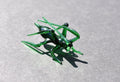 May include: A green glass grasshopper figurine with long legs and antennae.