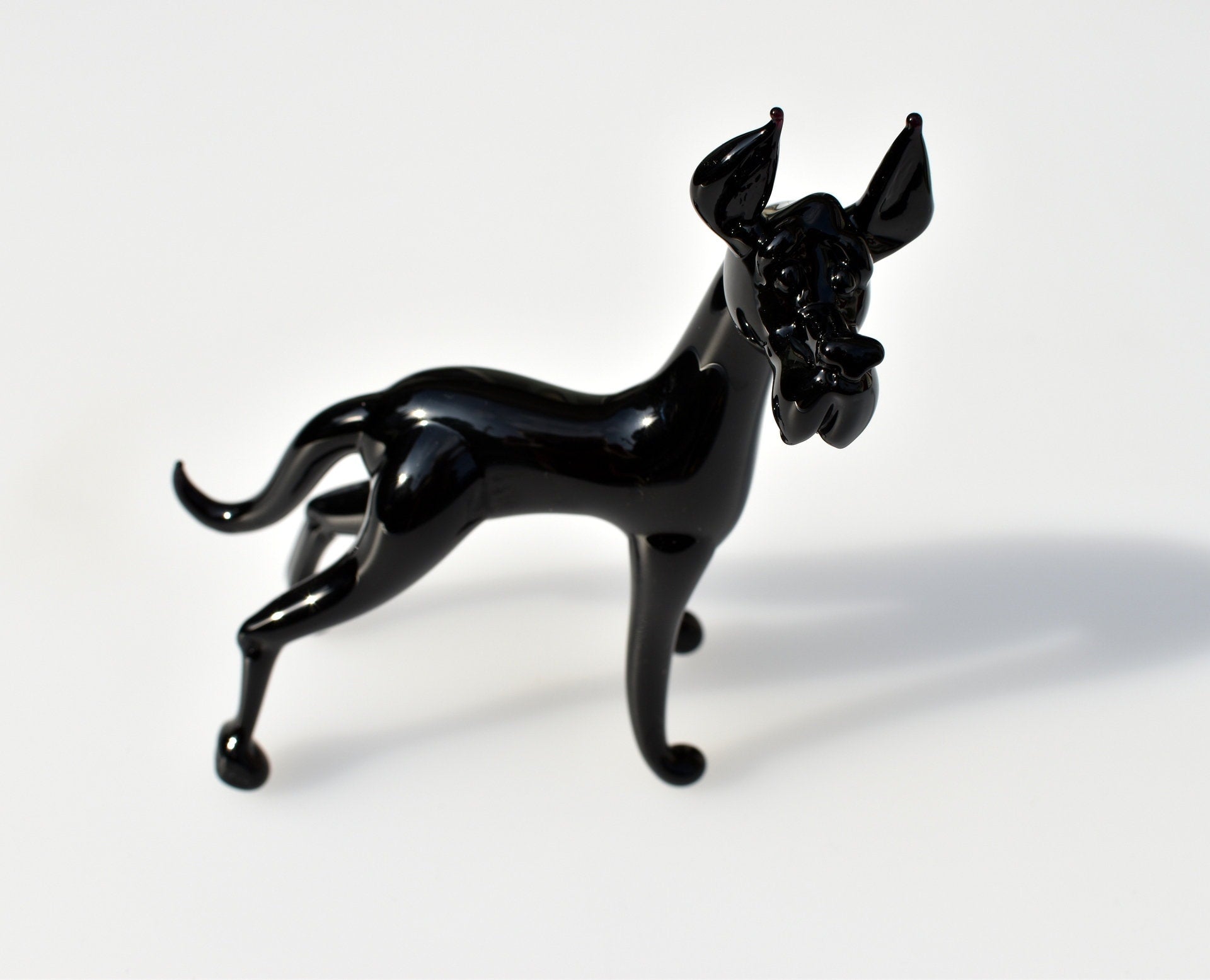 Black Glass Great Dane. Detailed figurine with a lot of character and personality.  Excellent addition to your glass menagerie collection.