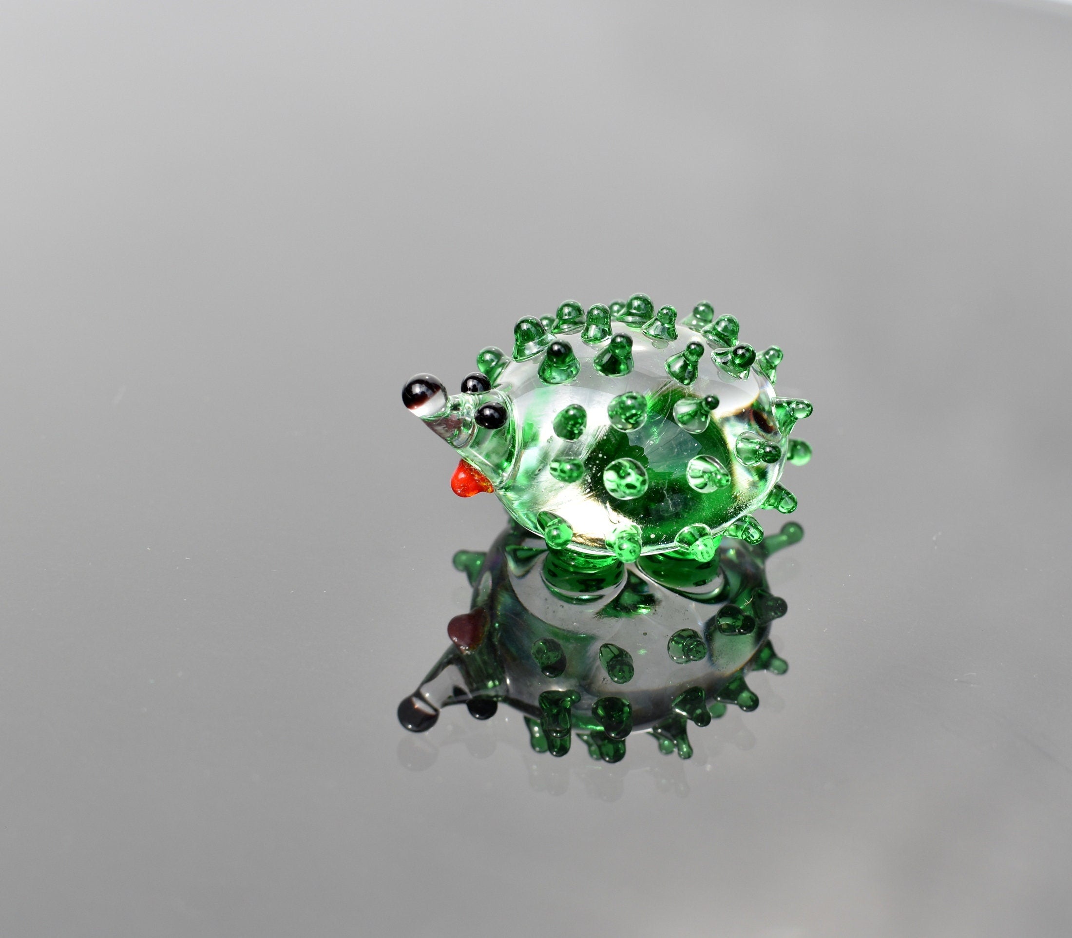 Green clear  color glass cute  hedgehog. Whimsical figurine with a lot of  personality. Excellent addition to your glass collection.