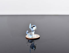 Cute Tiny light blue glass dog. Whimsical figurine with a lot of character and personality. Excellent addition to your collection.
