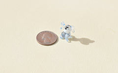 Cute Tiny light blue glass dog. Whimsical figurine with a lot of character and personality. Excellent addition to your collection.