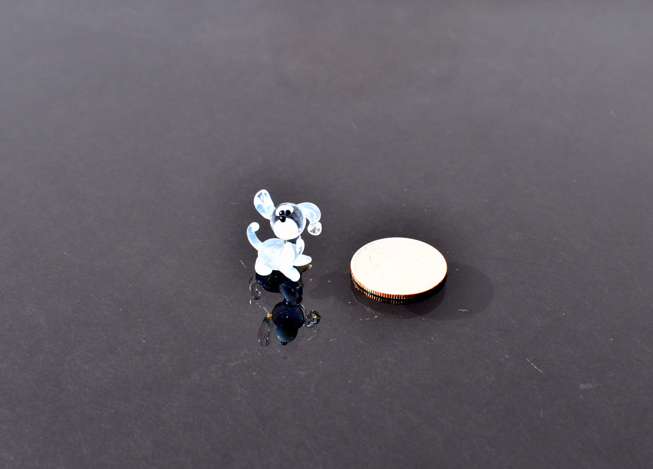 Cute Tiny light blue glass dog. Whimsical figurine with a lot of character and personality. Excellent addition to your collection.