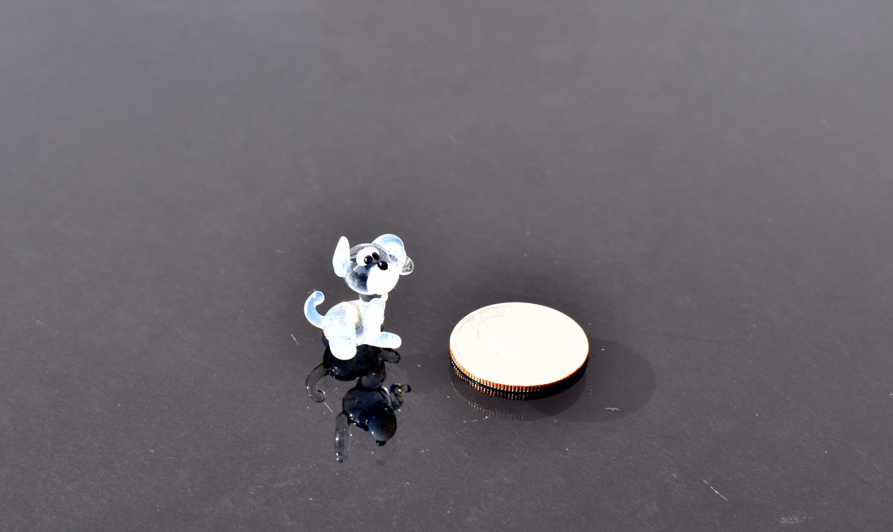 Cute Tiny light blue glass dog. Whimsical figurine with a lot of character and personality. Excellent addition to your collection.