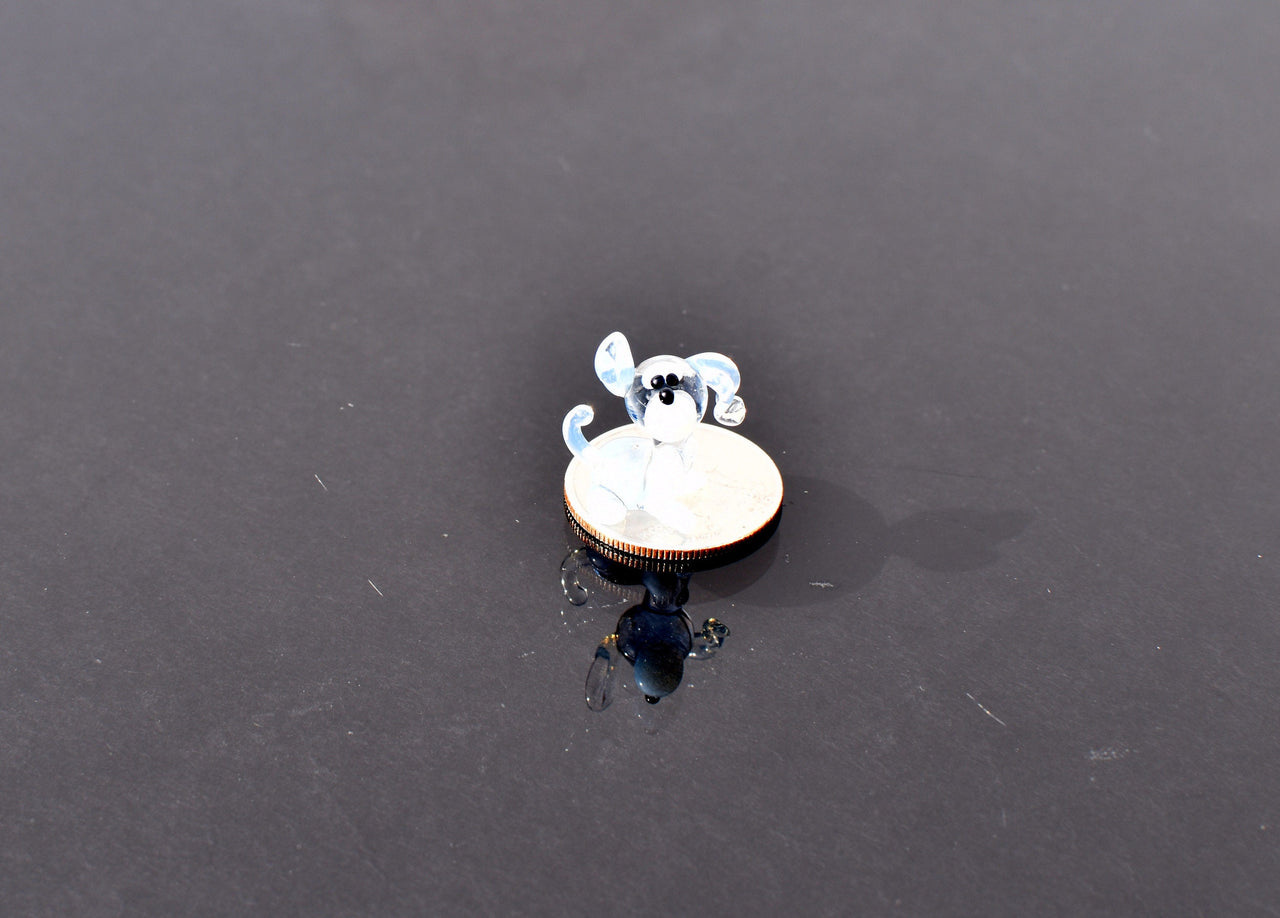 Cute Tiny light blue glass dog. Whimsical figurine with a lot of character and personality. Excellent addition to your collection.