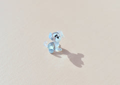 Cute Tiny light blue glass dog. Whimsical figurine with a lot of character and personality. Excellent addition to your collection.