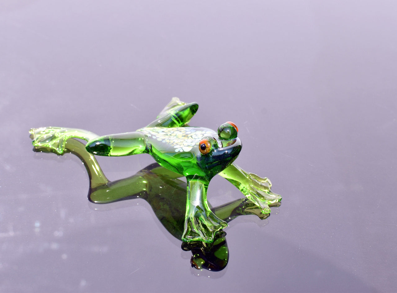 Jumping green glass  frog. Whimsical figurine with a lot of character and personality. Excellent addition to your glass collection.