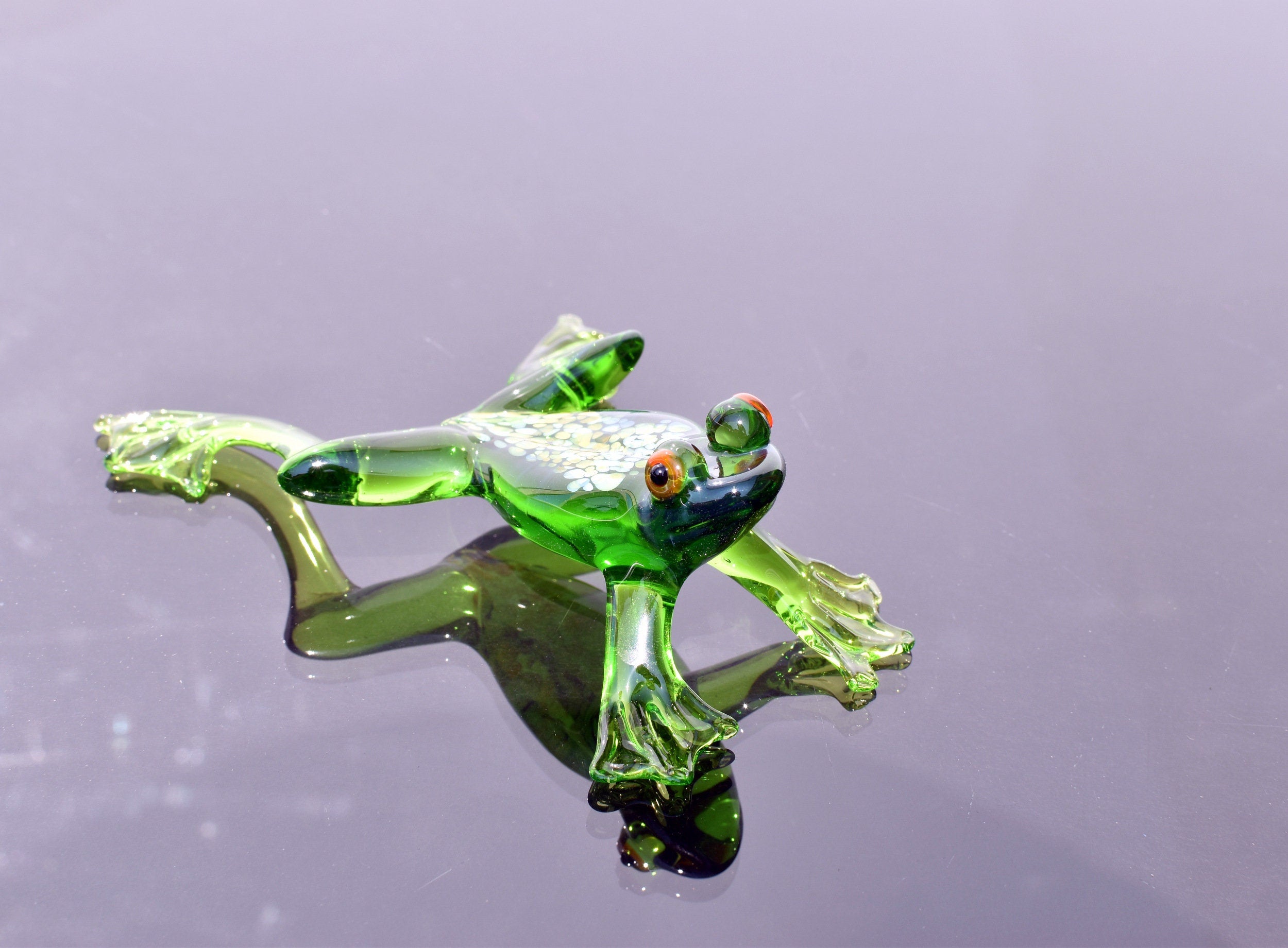 Jumping green glass  frog. Whimsical figurine with a lot of character and personality. Excellent addition to your glass collection.