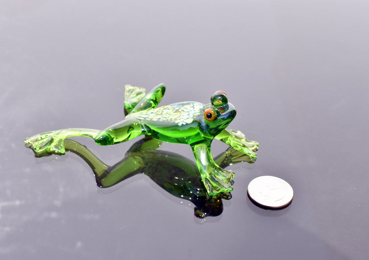 Jumping green glass  frog. Whimsical figurine with a lot of character and personality. Excellent addition to your glass collection.