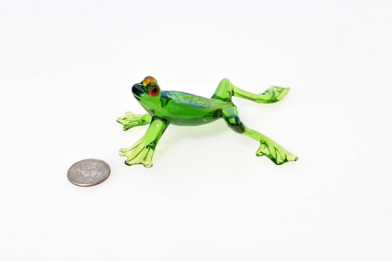 Jumping green glass  frog. Whimsical figurine with a lot of character and personality. Excellent addition to your glass collection.