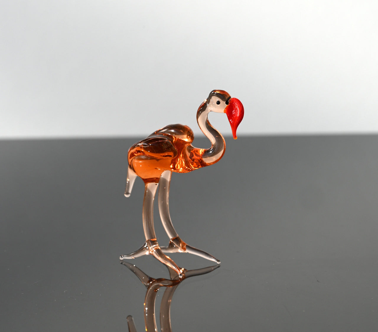 Rosy transparent Glass Flamingo. Detailed figurine with a lot of personality.  Excellent addition to your glass animals collection.
