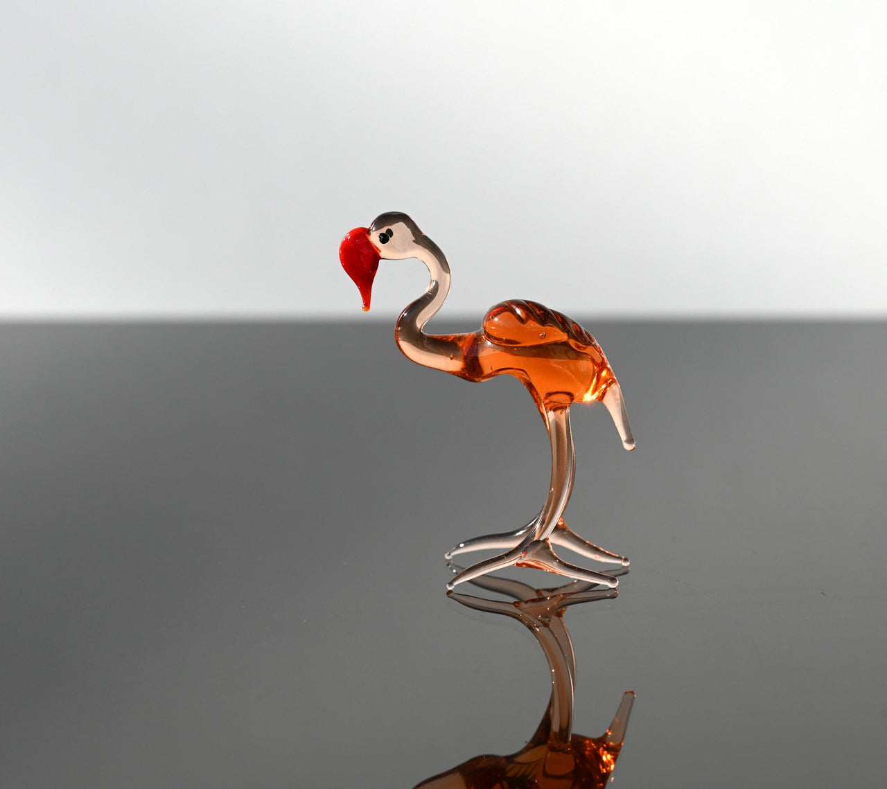 Rosy transparent Glass Flamingo. Detailed figurine with a lot of personality.  Excellent addition to your glass animals collection.