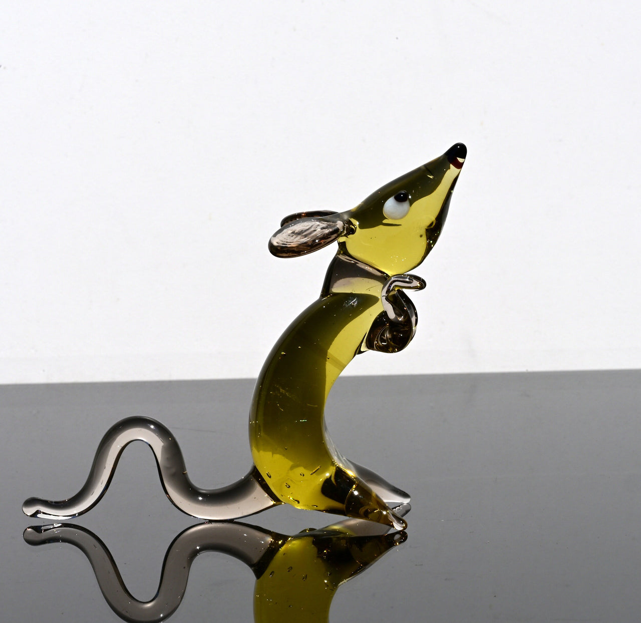 Cute amber- clear glass rat. Detailed figurine with a lot of personality.  It's an excellent addition to your glass animals collection.