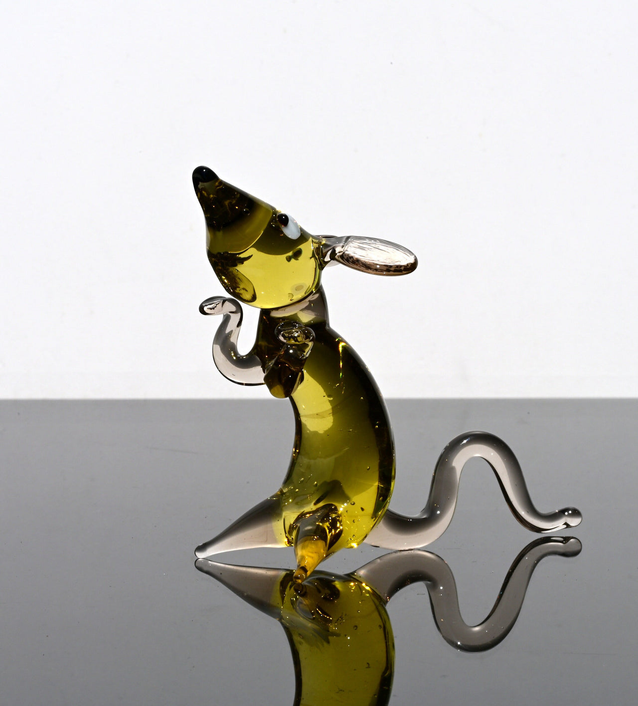 Cute amber- clear glass rat. Detailed figurine with a lot of personality.  It's an excellent addition to your glass animals collection.